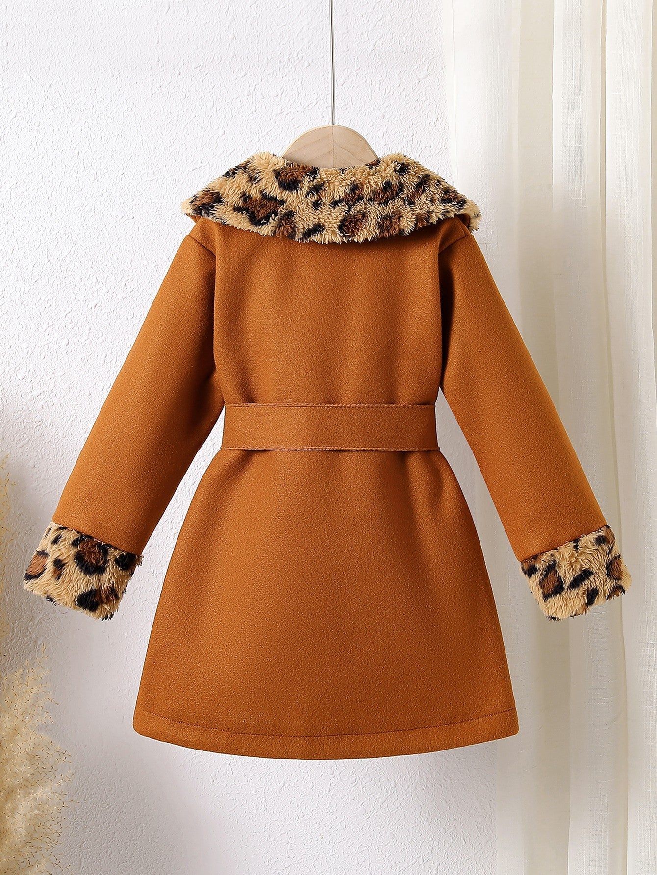 Abrigo de terciopelo suave con toque cálido y detalles de piel estampada.